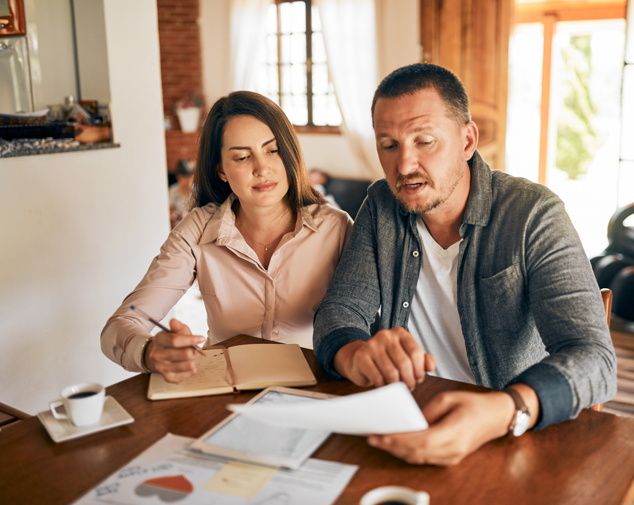 A business owner and his partner working through the accounts together at home